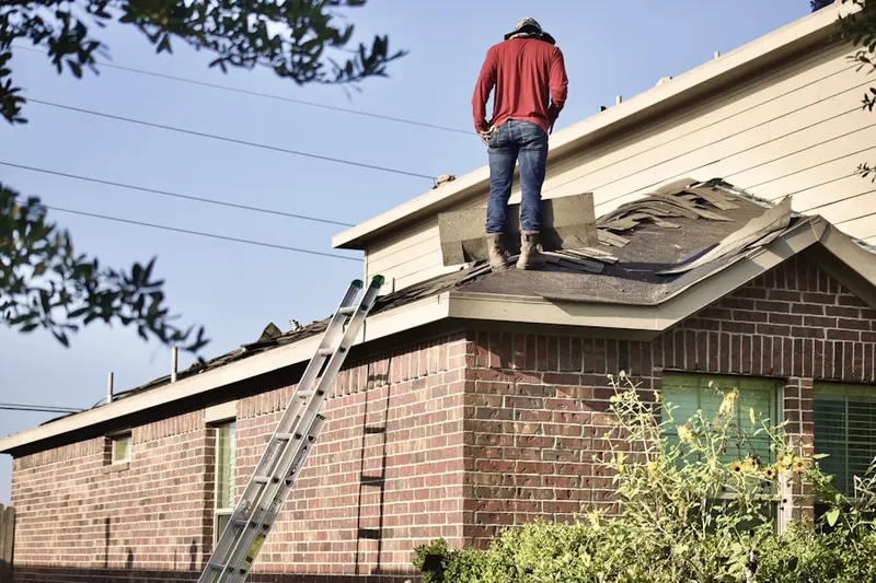 Professional roofer working on a residential roof in Towne Centre Place